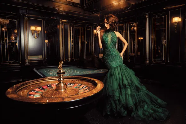 A man focused on his laptop with live stats in the background, highlighting the dedicated sports and gaming features of the 2G777 mobile app.