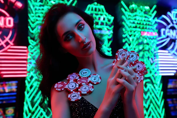 2G777 Slots — Thousands of exciting themes and jackpots A stylish woman beside vibrant slot machines displaying glowing sevens, showcasing the variety of top slots at 2G777.