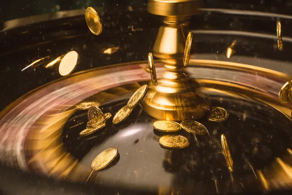 A woman smiling while playing online games on her laptop, surrounded by neon casino elements, showcasing 2G777’s diverse game collection.