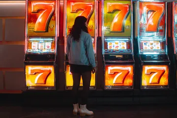 A vibrant slot machine bursting with lights and winning icons, highlighting the thrill of 2G777’s top-rated slot titles.