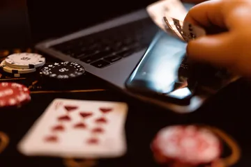 2G777 Slots — Thousands of thrilling machines await A woman smiling by bright slot machines showing lucky symbols, showcasing the exciting slot offerings at 2G777.